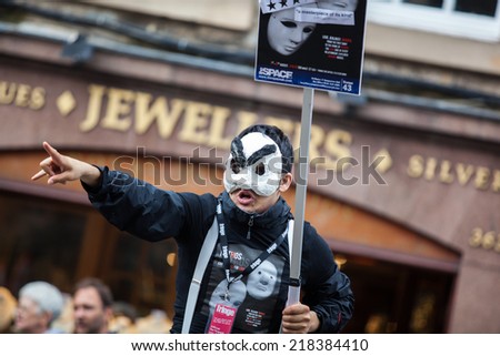 EDINBURGH, SCOTLAND: AUGUST 6, 2014: Artist with mask performing on Fringe festival. Fringe is the very popular and largest arts festival in the world.