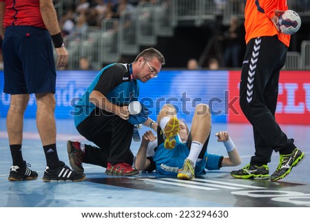 ZAGREB, CROATIA - OCTOBER 11, 2014: EHF Men\'s Champions League, match between HC Zagreb and HC Metalurg. Injured Goce GEORGIEVSKI (9) receiving medical help on the floor.