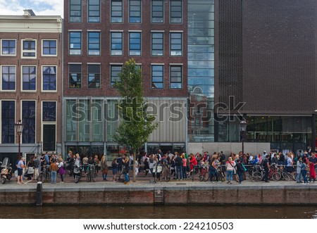 AMSTERDAM - NETHERLANDS: AUGUST 13, 2014: People waiting in line in front of the Anne Frank House, one of Amsterdam\'s most popular tourist attraction.