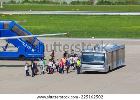 ZAGREB, CROATIA - APRIL 28, 2013:  Passengers leaving airport bus and boarding the plane at Pleso Airport.