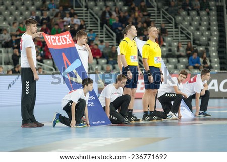 ZAGREB, CROATIA - DECEMBER 9, 2014: EHF Men\'s Champions League, match between HC Zagreb and HC Paris Saint-Germain. Referees standing next to League flag before the match.