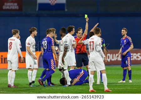 ZAGREB, CROATIA - MARCH 28, 2015: EURO 2016 qualifiers, group H - Croatia VS Norway. Referee showing yellow card.