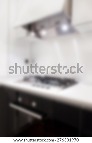 Blurred detail of the black kitchen with the open hood