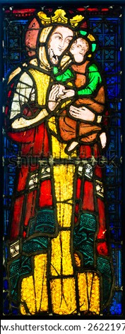 GLASGOW, SCOTLAND - MARCH  19, 2015: Stained glass panel made  in France in the 14th Century, depicting Virgin and Child, exhibited in The Burrell Collection