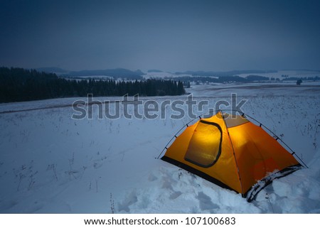 Tourist tent set in a winter snowy field