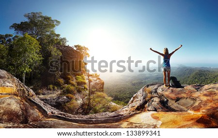 Hiker With Backpack Enjoying Valley View From Top Of A Mountain