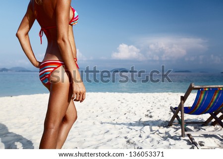 Young lady standing on a tropical beach Young lady standing on a tropical beach