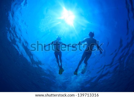 Young Couple Snorkeling Together In A Topical Sea