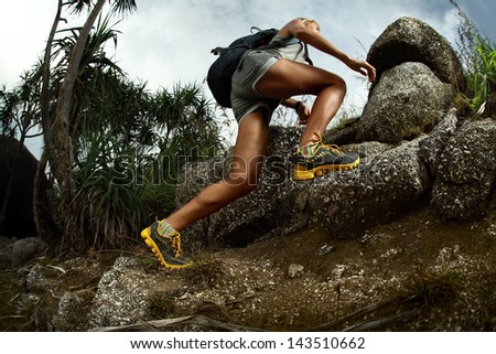 Hiker With Backpack Crossing Rocky Terrain