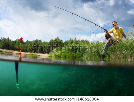 Young smiling man fishing on a green pond\'s coast with underwater view of weed on a bottom