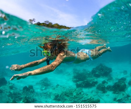 Young lady snorkeling in a clear tropical sea