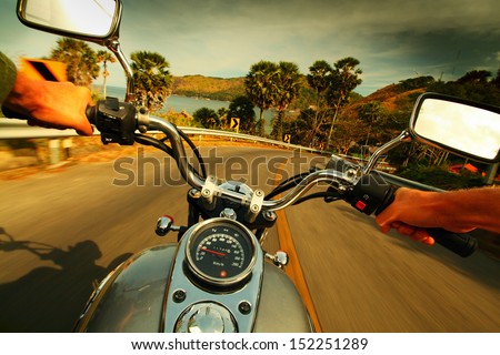 Driver Riding Motorcycle On An Asphalt Road In A Tropics