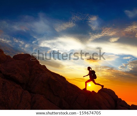 Hiker With Backpack Crossing Rocky Terrain