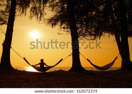 Young Lady Relaxing In The Hammock On The Tropical Beach And Enjoying Sea View