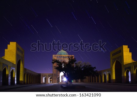 Inner yard of madrassa of Poi Kalyan oriental complex at night with star trails. Bukhara, Uzbekistan