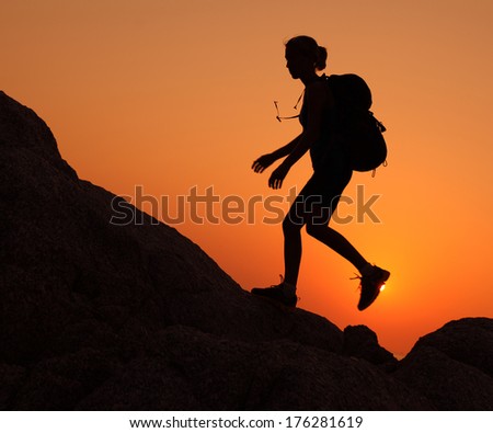 Silhouette Of The Hiker Walking On Rocky Terrain During Sunset