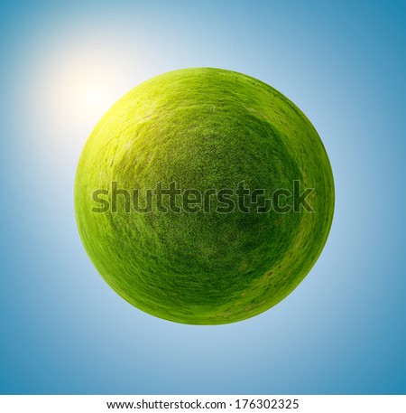 Green grass sphere on a blue clear background