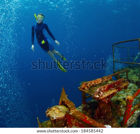 Free diver exploring the ship wreck in tropical sea