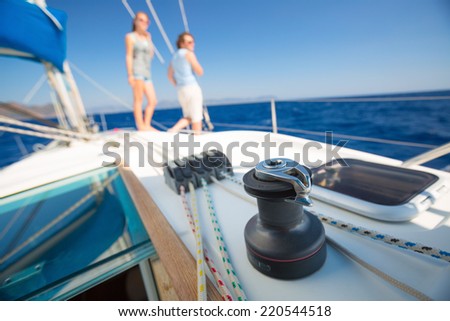 Young couple sailing in a sea. Focus on a gear