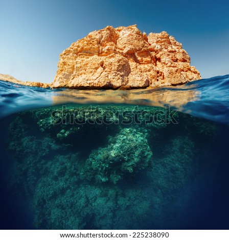 Split shot with coral reef underwater and rocky land of the Ras Muhammad National Park, Red Sea, Egypt