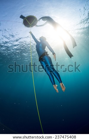 Free diver ascending along the rope