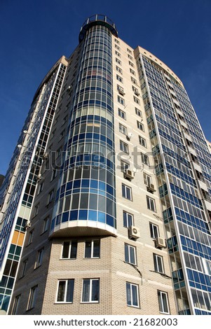 Modern building with blue windows on a blue sky background