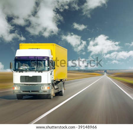 Yellow truck on road under blue sky