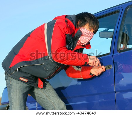 Young guy braking door of a car