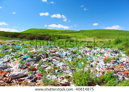 Garbage dump on green meadow