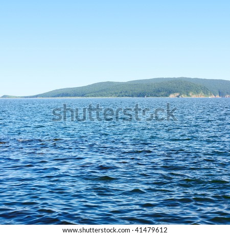 Blue sea and land under blue sky