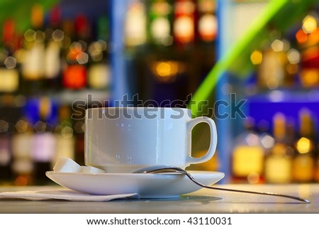 Cup with tea on table in night club