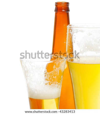 Beer with foam in glasses and bottle