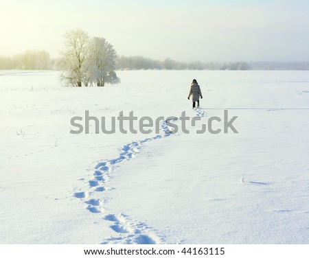 Man walking on deep snowy field