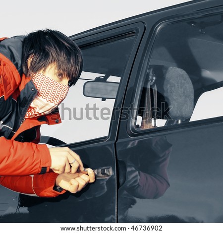Young man breaking door of a car