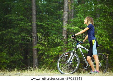 Woman on bike in forest