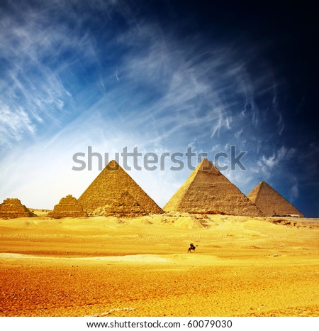 Great pyramids in Giza valley and rider on camel. Egypt