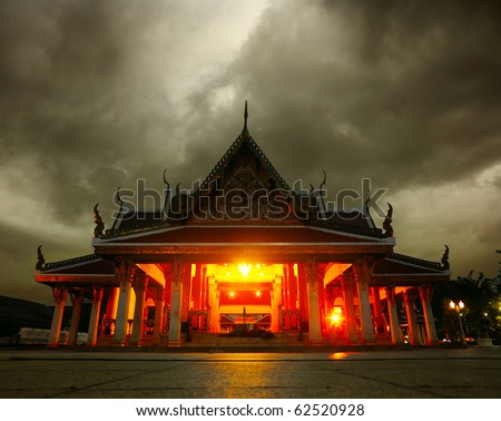 Ancient praying building at night with dark clouds