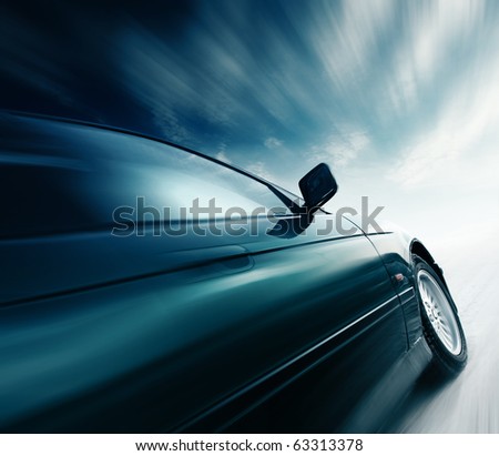 Blurred car and blue sky with clouds