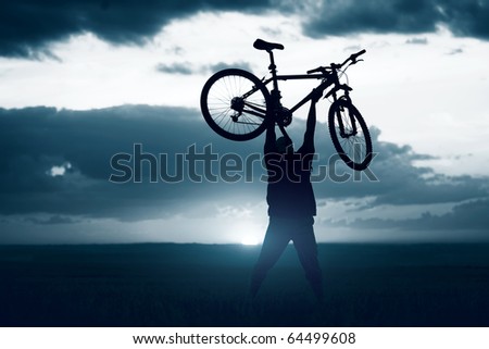 Man with bicycle lifted above him