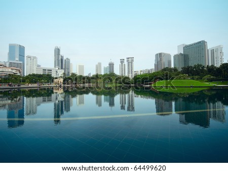 Buildings of a city with reflection in water. Kuala Lumpur