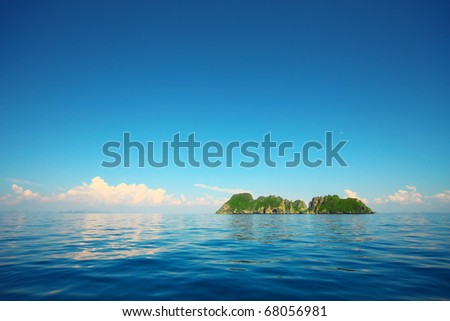 Tropical island in a blue sea and blue sky