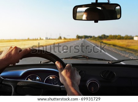 Drivers\'s hands on stearing wheel of a car