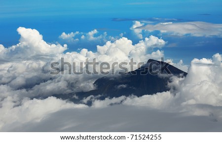 Mountain Rinjani among clouds. View frome plane. Lombok island. Indonesia