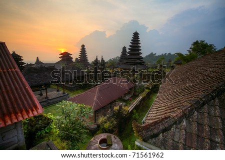 Yard with green trees and buildings of indonesian old temple Pura Besakih at sunset light. Bali. HDR image
