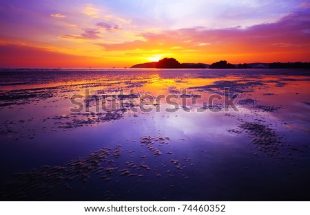 purple sunset beaches. stock photo : Purple sunset over a each during low tide