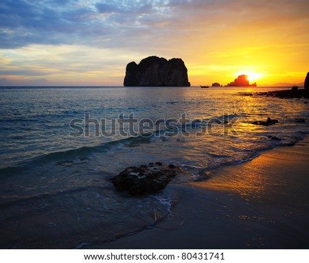 Sunset on sea with islands on the horizon