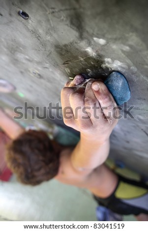 Young man climbing indoor wall