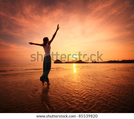 Young woman walking on a sandy beach