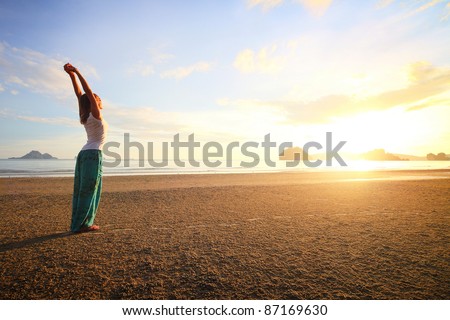 Young woman standing on a sandy beach