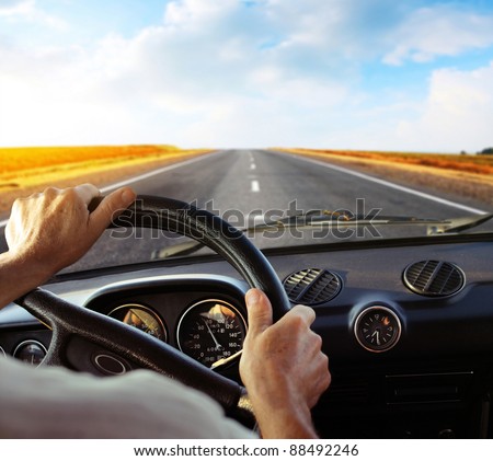 Driver\'s hands on a steering wheel